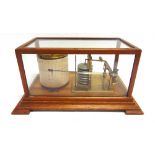 A BAROGRAPH IN AN OAK CASE 17.5cm high, 36cm wide, 21cm deep.