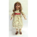 A BISQUE SOCKET HEAD DOLL possibly by Paul Schmidt, with a replacement long brown wig, sleeping