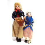 TWO 19TH CENTURY BISQUE SHOULDER HEAD DOLLS each with integrally fashioned costume, the largest 26cm