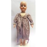 A STROBEL & WILKIN BISQUE SOCKET HEAD DOLL with a replacement brown wig, sleeping grey glass eyes,