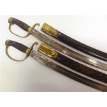 A MATCHED PAIR OF VICTORIAN CONSTABULARY SHORT SWORDS the 59.5cm curved steel blades without