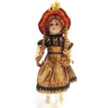 AN ARMAND MARSEILLE BISQUE SOCKET HEAD DOLL with a replacement plaited auburn wig, sleeping blue-