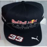 Max Verstappen Formula 1 memorabilia, comprising a Red Bull cap signed #33 on peak in black marker