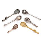 Six tennis racquet brooches, including two being J Jeffreys advertising racquets, gilt metal and
