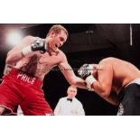 Twelve framed boxing photographs, comprising action shots and ringside shots, some featuring winning