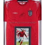 David Beckham signed red England replica jersey 2004/06, signed in black marker pen, mounted with an