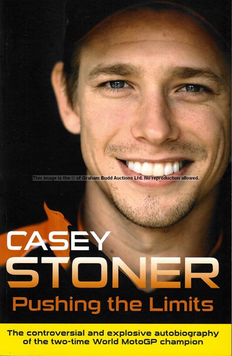 Casey Stoner signed MotoGP memorabilia, comprising signed book and 8 by 12in. action photograph of