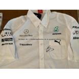 Lewis Hamilton Formula 1 memorabilia, comprising a Mercedes pit crew shirt and 8 by 10in. Mercedes