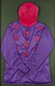 Framed racing silks of Mrs Jean Hislop, owner of Brigadier Gerard, purple silks with red spots and