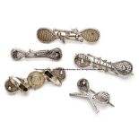 Five Victorian silver tennis brooches, comprising three double racquet brooches; one with shoes