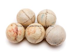 Five Jeu de Paume leather balls, of spherical form with stitched seams, diameter 5cm., wear to