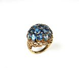 9 ct yellow gold blue topaz bombé style cluster ring.