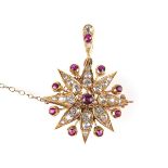Yellow gold ruby and diamond star brooch.