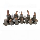 Twelve matching hand bells by Symondson.