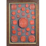 A framed collection of red wax seals, probably 19th century.