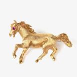 Garrard & Co 18 ct yellow gold ruby horse brooch.