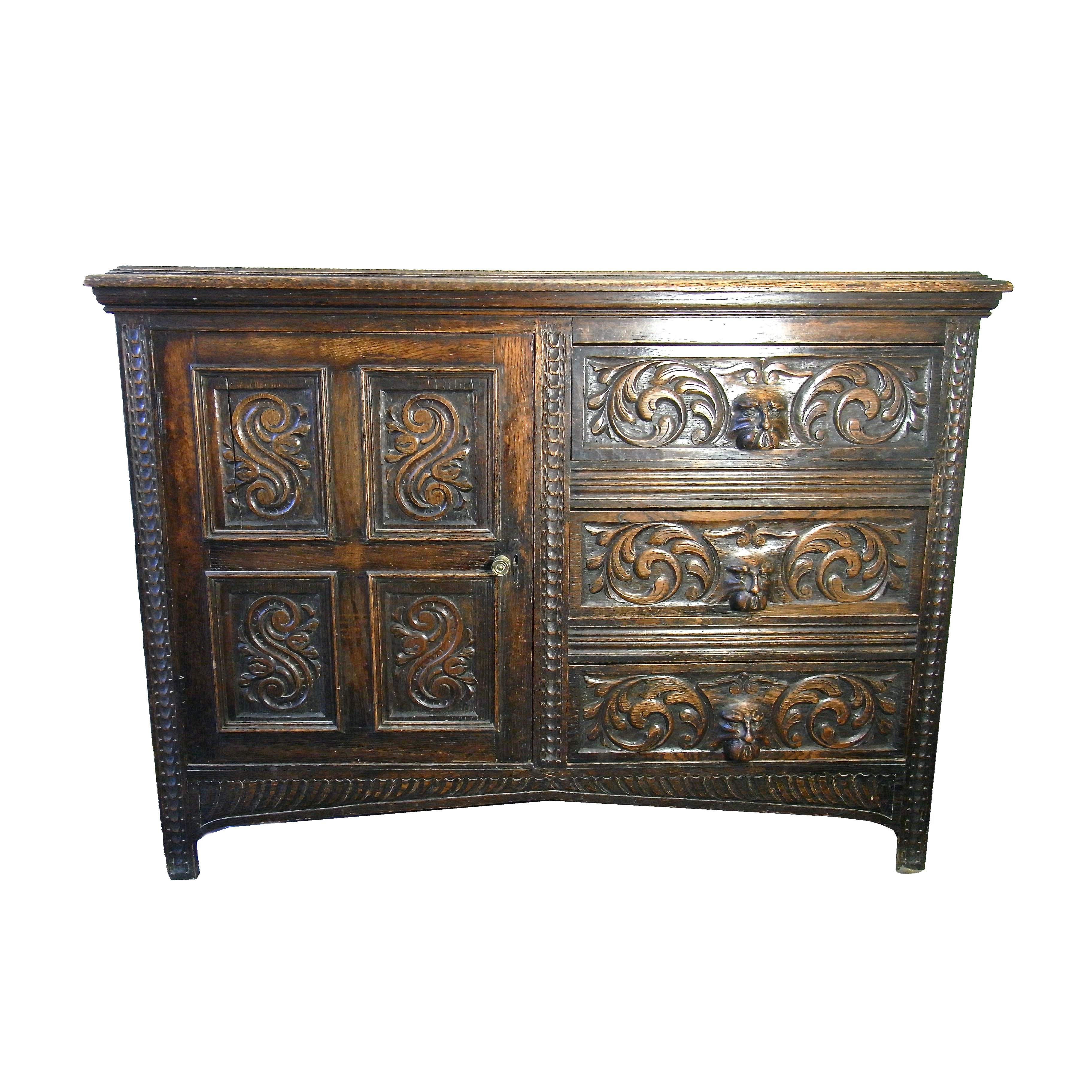 A Victorian carved oak side cupboard