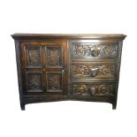 A Victorian carved oak side cupboard