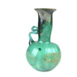 A small Roman hand blown turquoise glass decanter vessel