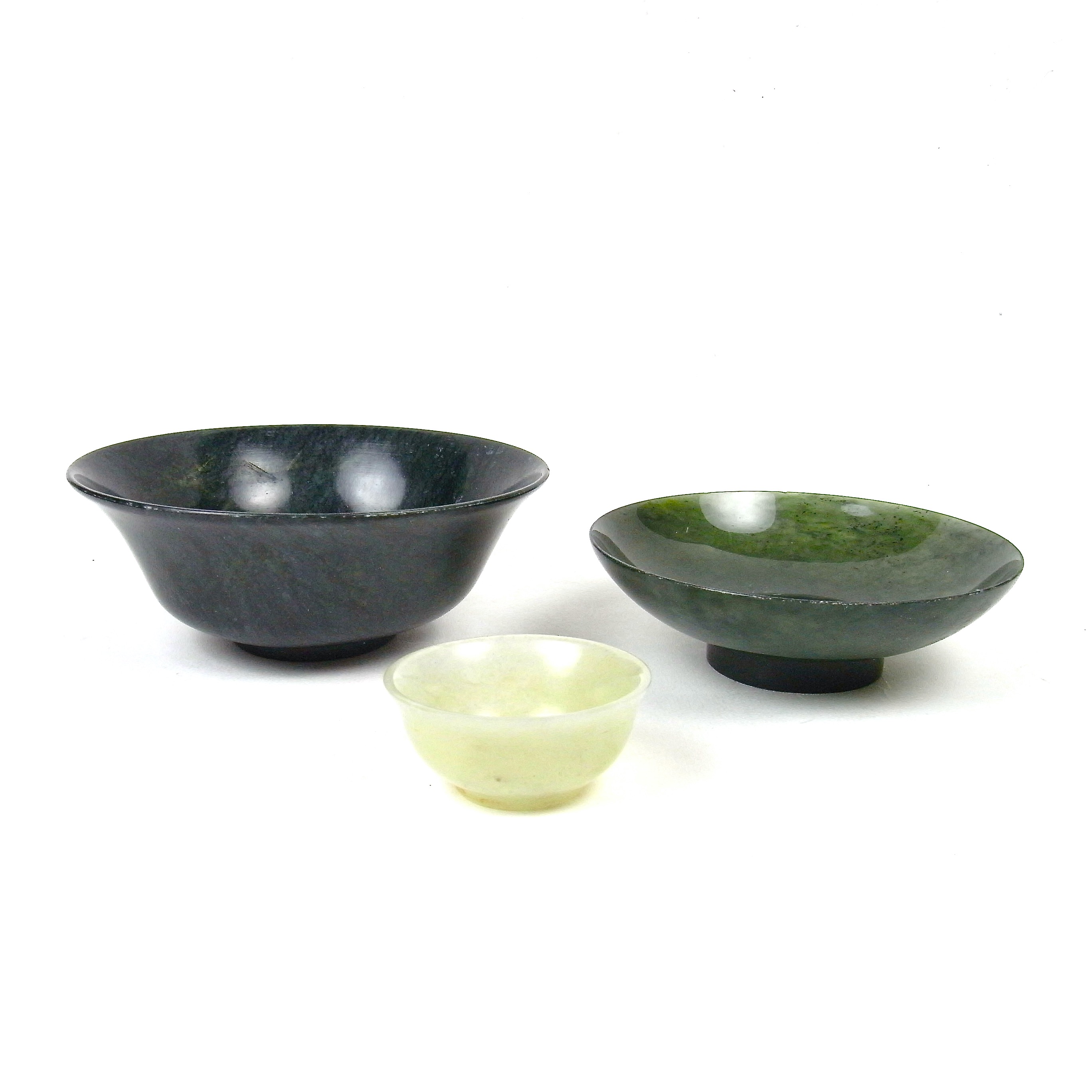 A group of three carved jade and greenstone bowls, 20th century