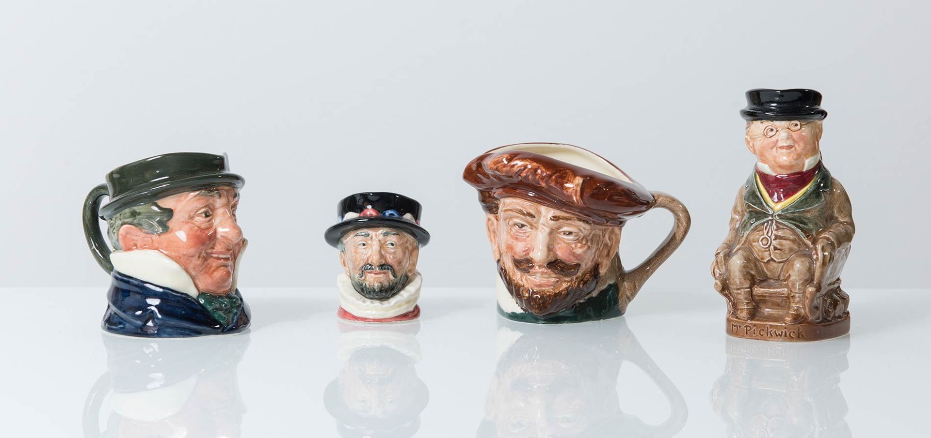Royal Doulton, Quattro piccole “Character Mug”, Inghilterra, XX secolo.