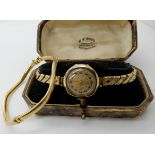 A 9ct gold ladies vintage watch with gold plated expanding strap and a 9ct gold bangle, combined