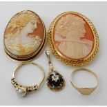 A 9ct mounted shell cameo brooch, and a yellow metal mounted example, a 9ct pearl and garnet ring