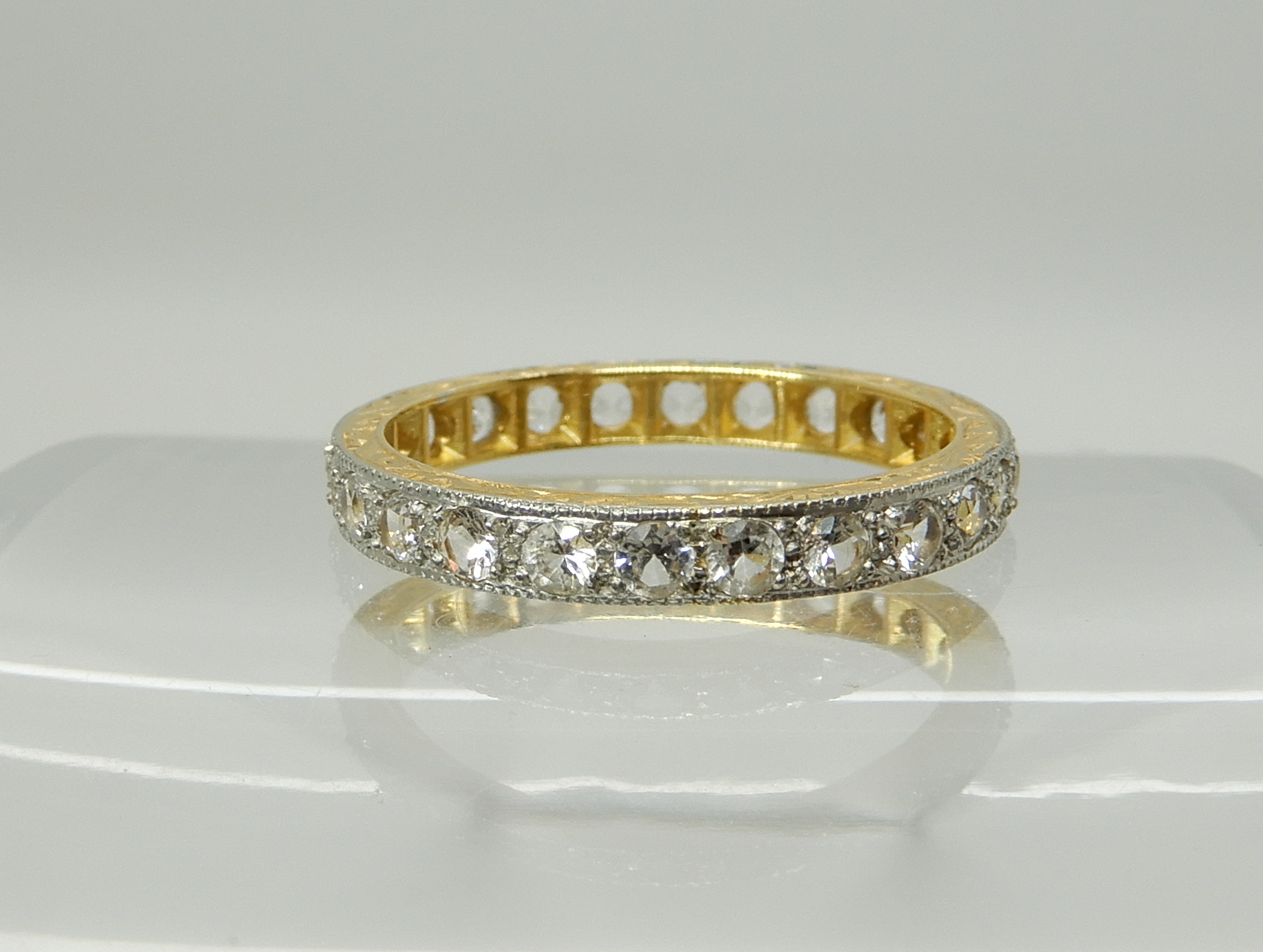 An 18ct gold clear gem set full eternity ring, size N1/2, weight 2.6gms Condition Report:
