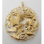 A bright yellow metal phoenix pendant with Chinese stamps to the reverse, diameter approx 6cm,