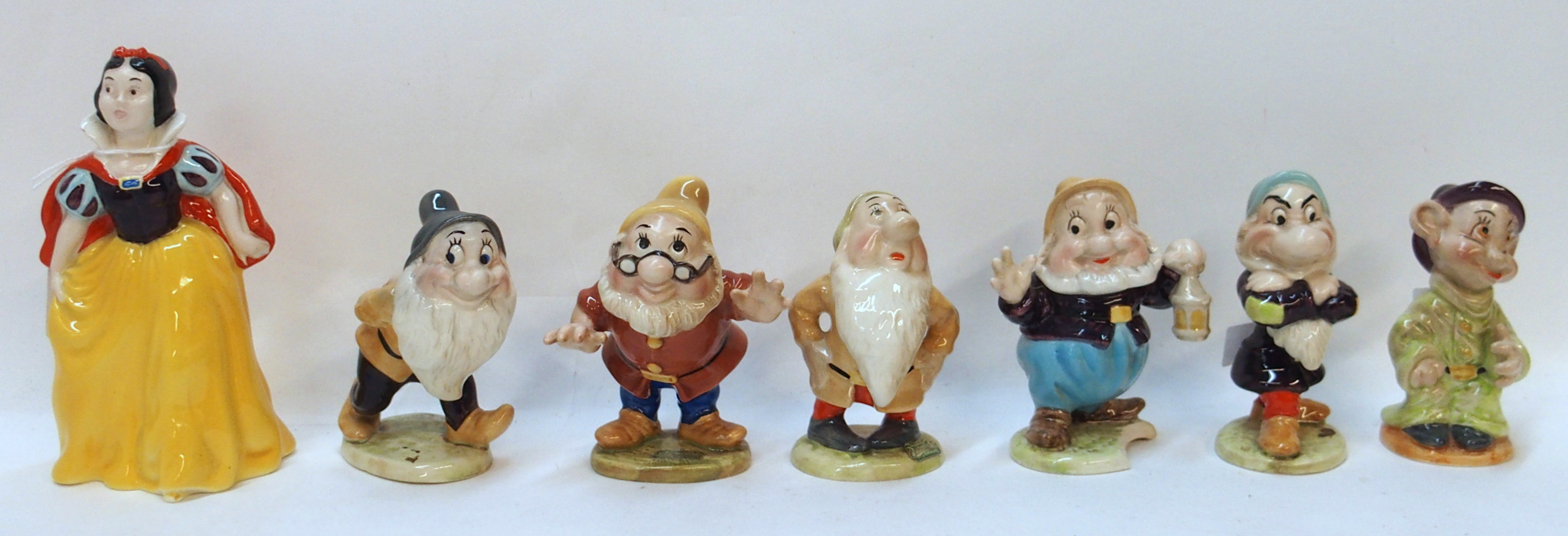 *WITHDRAWN* A Beswick Disney group of Snow White and six dwarfs including Bashful, Dopey, Sleepy