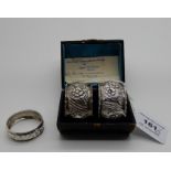 A lot comprising a cased pair of silver napkin rings, Birmingham 1915 and a single napkin ring,