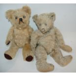 An early Steiff Teddy bear, worn, 44cm high, another Teddy bear and another (3) Condition Report: