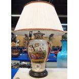 A large continental table lamp painted with scenes of figures in a landscape Condition Report: