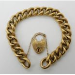 A 9ct gold curb link bracelet with engraved detail, with a heart shaped clasp, length 20cm, weight