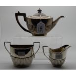A lot comprising a bachelor's silver teapot, Sheffield 1885 and a silver cream and sugar, London and