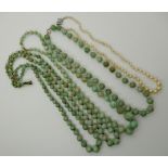 Three strings of green hardstone beads and a string of cultured pearls Condition Report: Not