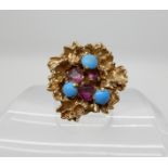 A 9ct gold retro ring set with turquoise and pink gems size O, weight 8.5gms Condition Report: