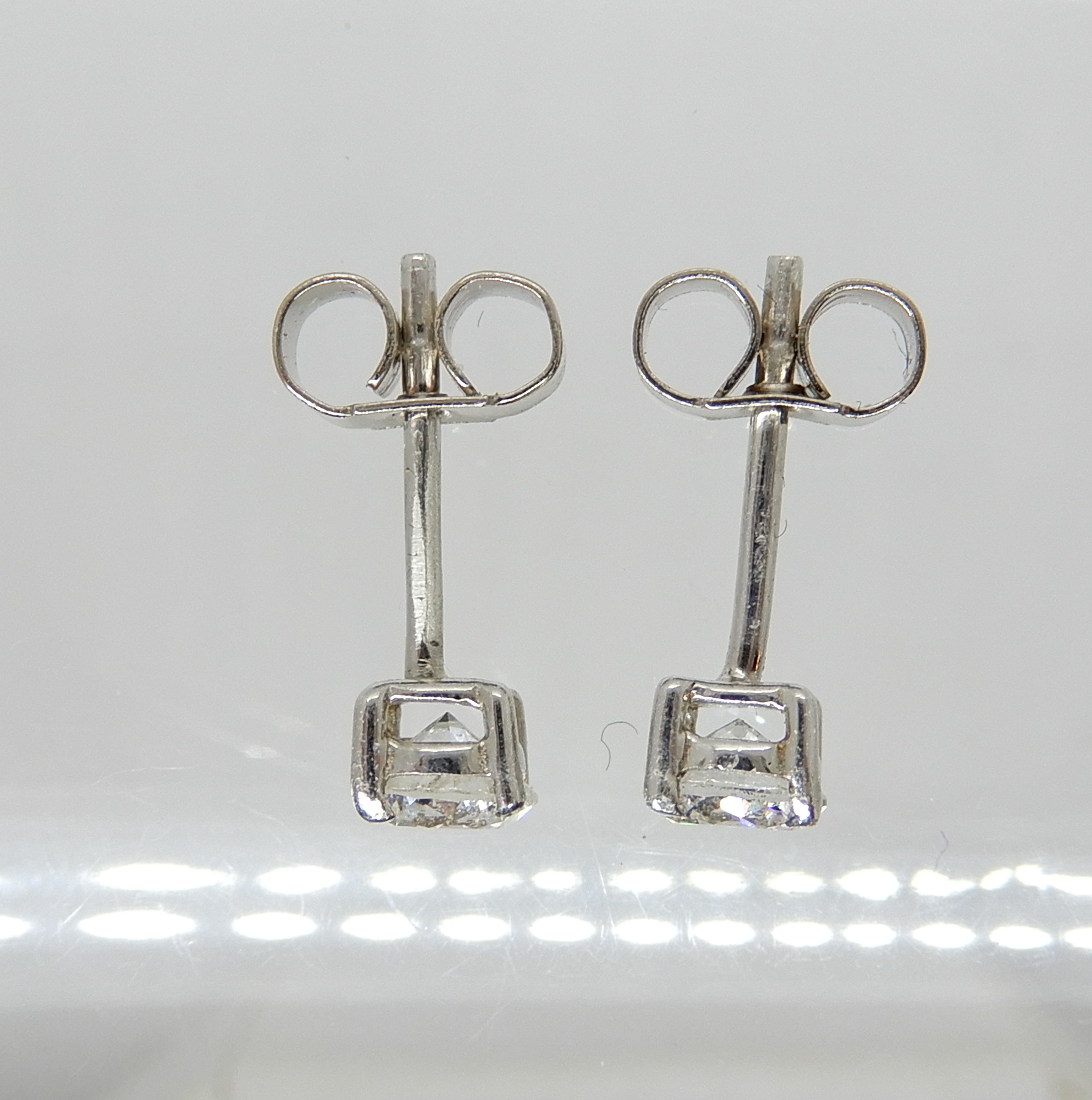 A pair of white metal (butterflies stamped 750) diamond stud earrings of estimated approx 0.50cts - Image 2 of 2