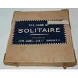 A John Jaques & Son solitaire board, 23cm diameter in original box with collection of marbles