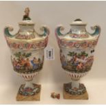 A pair of Capodimonte urns and covers, decorated with bacchanalian scenes Condition Report: