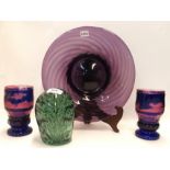 An end of day glass dump with bubble inclusions, a purple glass dish and a pair of blue flashed pink