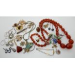 A string of amber beads, large silver and enamel flower brooch, fish pendant and other items