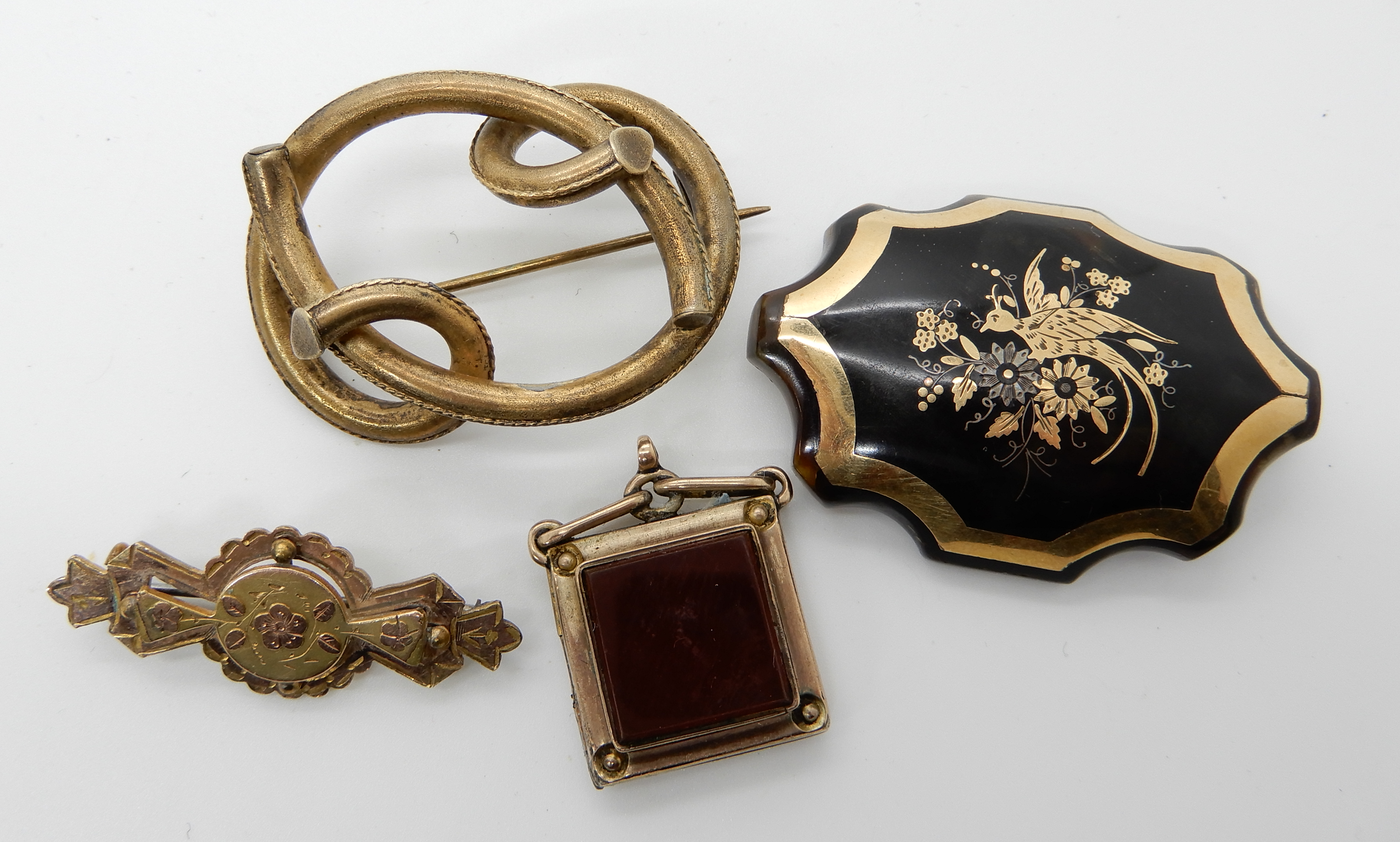 A pique wear brooch with a bird design and three vintage gold plated items Condition Report: Not