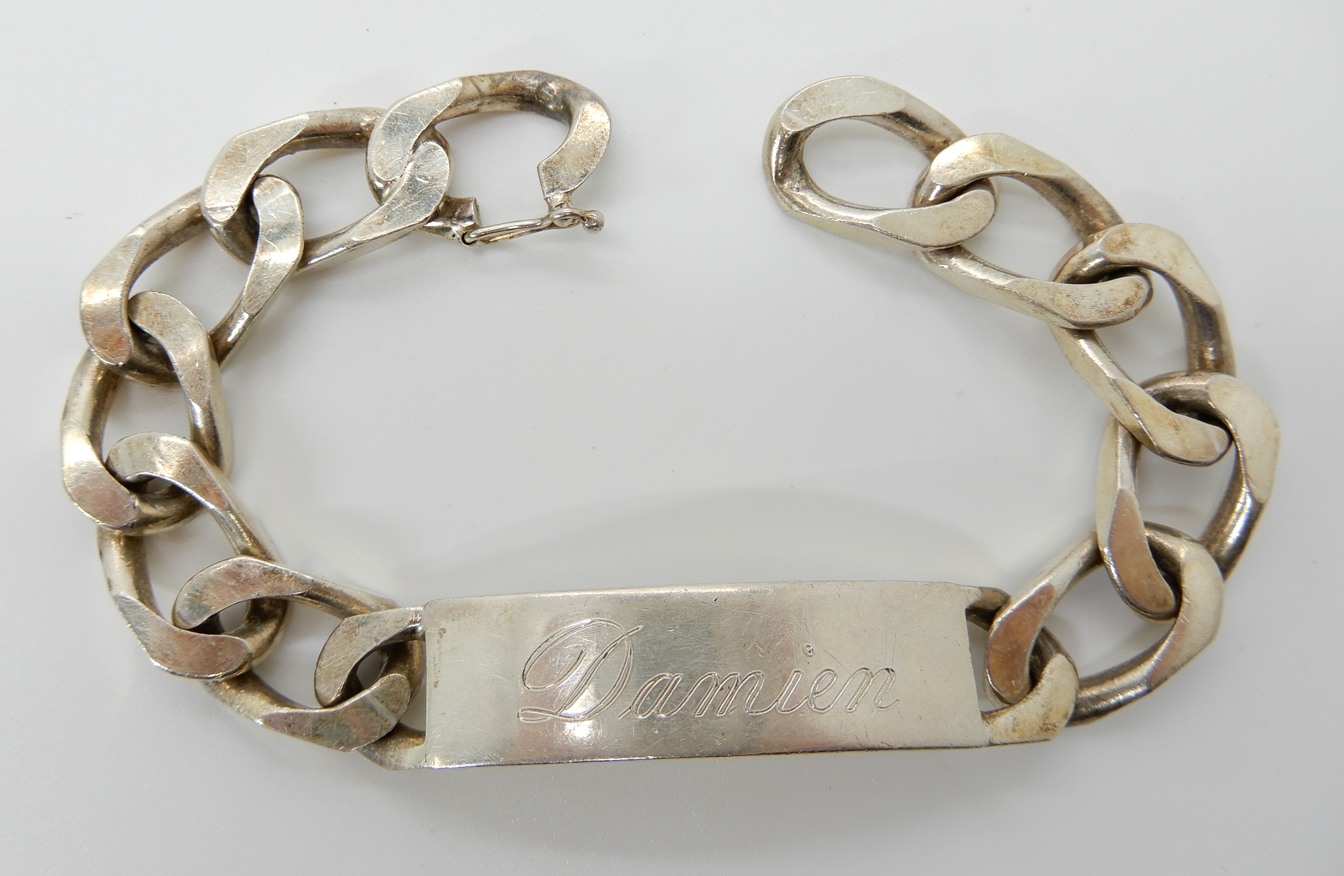 A gents silver curb link bracelet Condition Report: Not available for this lot