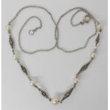 A 9ct white gold pearl set chain with lovers knot detail links, length 43cm, weight 3.5gms Condition