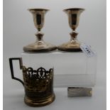 A lot comprising a pair of silver candlesticks, Sheffield 1792, a sterling silver money clip and a