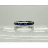A white metal sapphire set full eternity ring, size L, weight 3.3gms Condition Report: Some damage