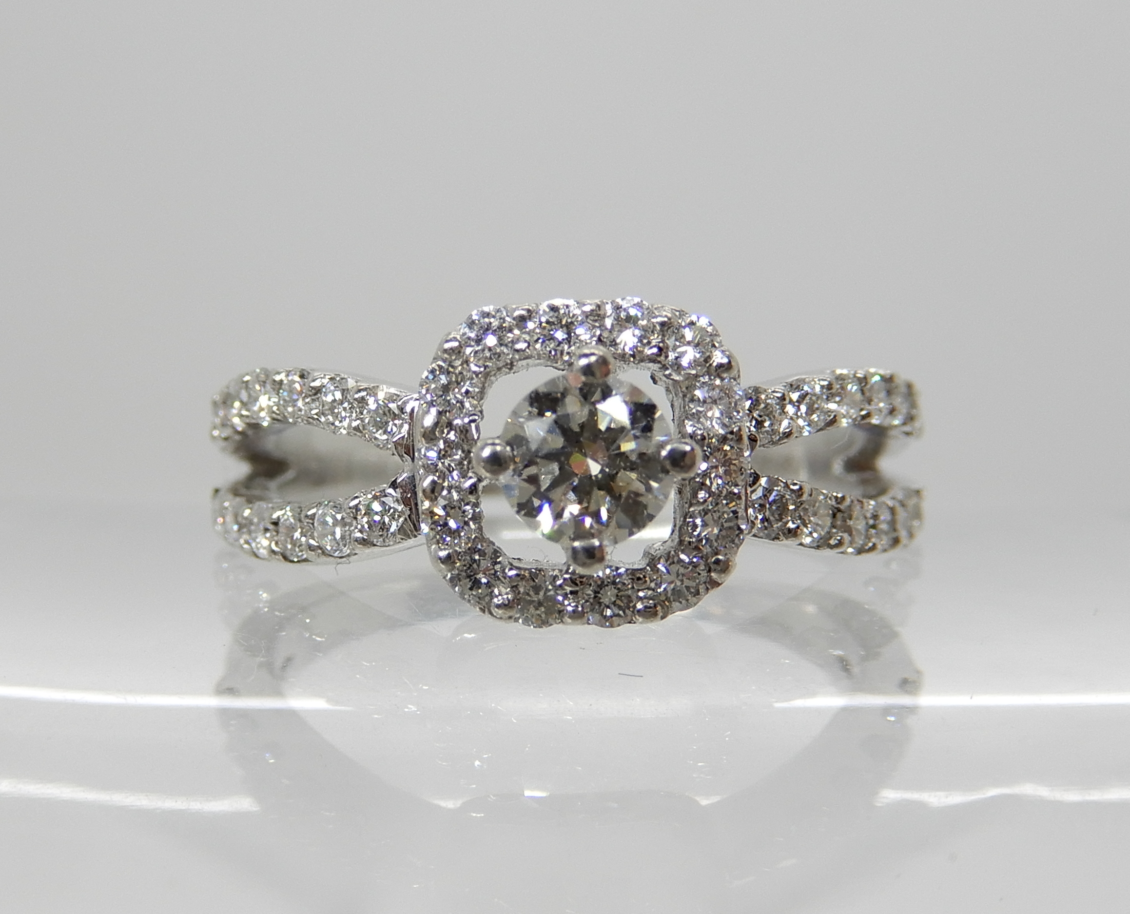 A platinum diamond cluster ring set with estimated approx 0.60cts of brilliant cut diamonds, the