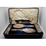A part silver mounted dressing table set, Birmingham 1938, lacking mirror (5) Condition Report:
