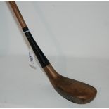 A scared-head putter the head stamped Simpson, Carnoustie, shaft stamped Made in Scotland